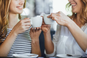 women drinking coffee tea at home